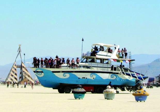 A 65-foot yacht that was pulled from the Tahoe Keys and placed on a cement truck chasis drives around the playa during Burning Man 2011 in Nevada&#039;s Black Rock Desert.