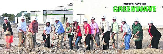 School officials had a Ground Breaking Ceremony Thursday at the site where the auxiliary gym will be built. Trustees, teachers and students were invited to break ground. From left are Chelle Dalager, Greg Koenig, Matt Hyde, Anne Smith, Mayor Ken Tedford, Hannah Isbister, Jordyn Rogers, Kathryn Whitaker, Carmen Schank, Kevin Lords, Rich Gent, Clay Hendrix, Ron Evan and Superintendent Dr. Sandra Sheldon.