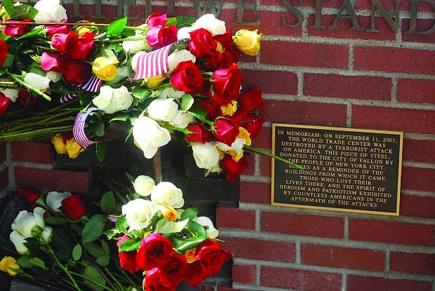 Flowers adorn a wall behind the Fallon City Hall  after a previous 9/11 ceremony remembered those who lost their lives on Sept. 11, 2001.