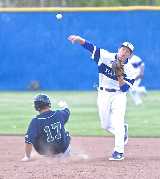 Senator 2nd baseman Jace Keema completes a double-play to end an inning against Damonte Ranch Thursday at Ron McNutt Field.