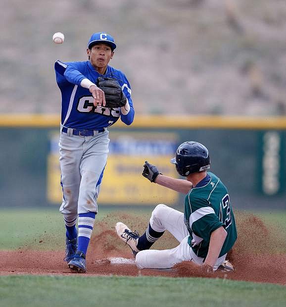 Carson Senator Josiah Pongasi attempts to turn a double play with Damonte Ranch&#039;s Jonny Damon sliding into second during the Senator&#039;s 2-1 victory, Reno, NV
