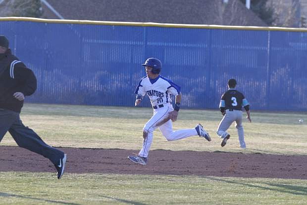 Gehrig Tucker out runs a relay throw to third base for a triple against North Valleys on Tuesday.
