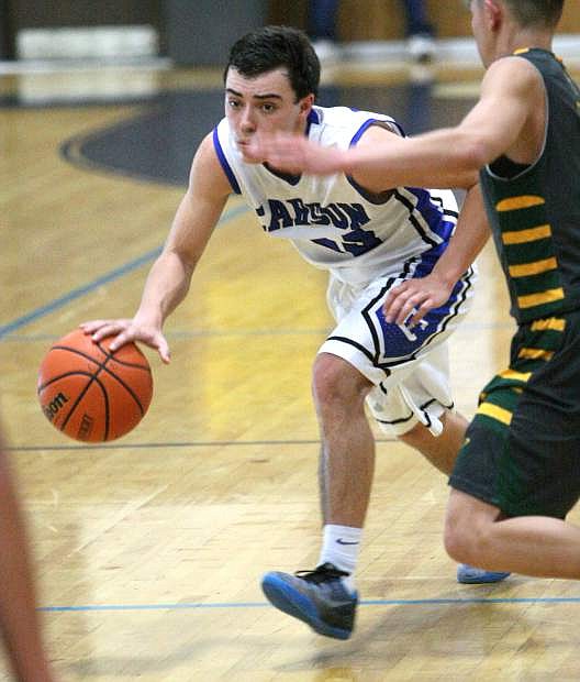 Guard Cody Azevedo brings the ball up the court against Manogue on Tuesday night.