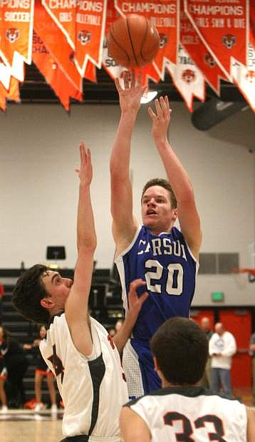 Tez Allen shoots a jump shot over the hands of a Tiger defender on Tuesday night.