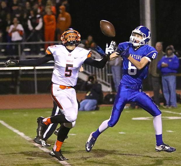Carson High&#039;s Connor Pradere catches a passover Douglas sophomore Tre Jackson for a 61-yard touchdown last seasont.