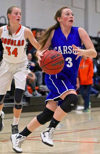 Carson&#039;s Melissa Glanzmann (3) drives past Douglas&#039; Hannah Carr (34) in a loss to the Tigers at Randy Green Court Friday night.