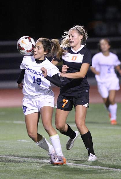 Julie Torres battles for the ball against a Douglas defender on Tuesday night.