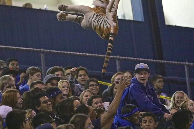 A CHS student throws a stuffed tiger in the stands Friday night as Carson manhandled the Douglas Tigers.