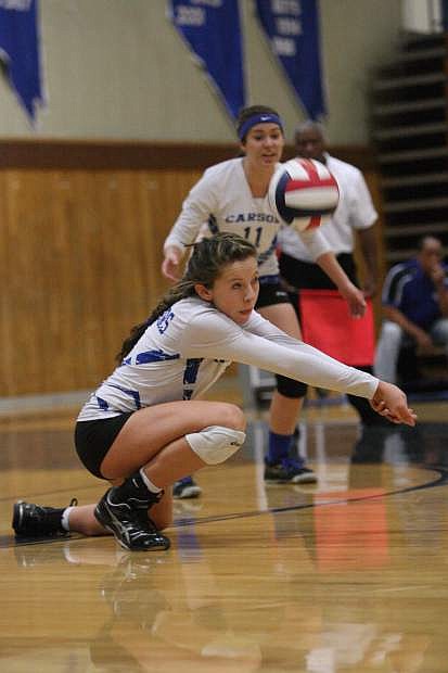 Carson&#039;s Jaycie Roberts digs the ball in a game against Douglas Thursday night at Carson High.