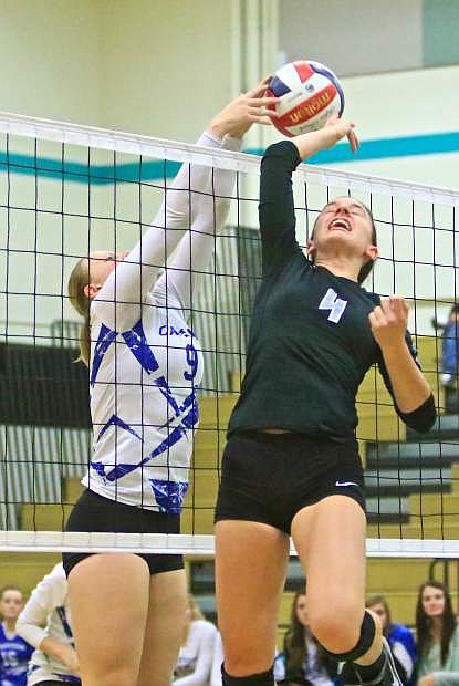 Carson&#039;s Maddie Jergesen (9) stuffs Reed&#039;s Annie Braun (4) at the net in a win over the Raiders at North Valleys High School last year.