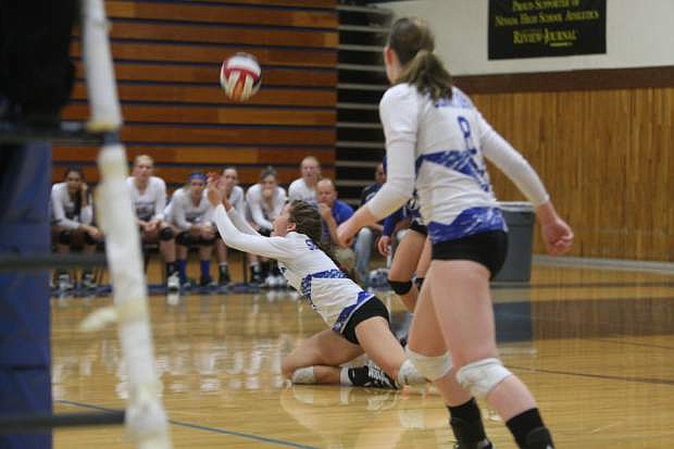 Jaycie Roberts dives to the floor for a dig against North Valleys on Tuesday night.