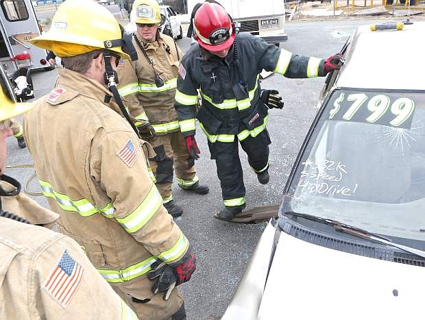 Captain Tom Raw and other Carson City firefighters work on an old Toyota during an extraction drill Saturday at Station 52.
