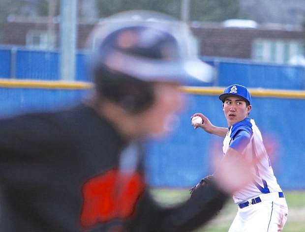 Carson 3rd baseman John Holton makes a throw to first base Saturday against Douglas at CHS.