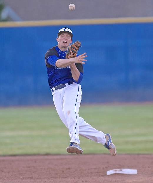 Carson 2nd baseman Jace Keema makes a throw back to first to notch a Senator out early in the game against McQueen at Ron McNutt Field Thursday.