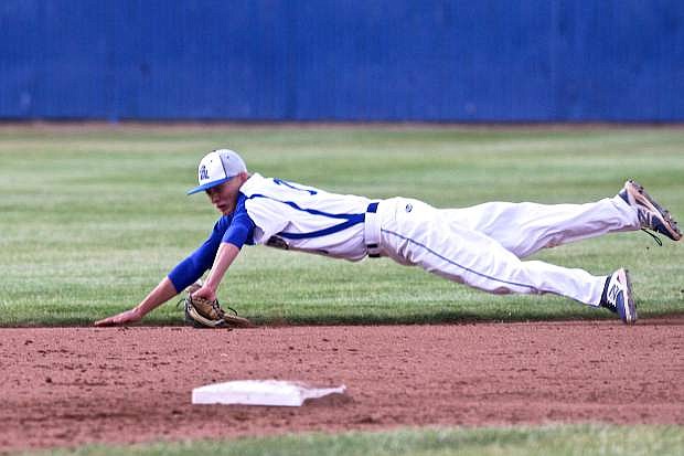 2nd baseman Connor Pradere attempts to make a diving catch in a game against Damonte Thursday night at Ron McNutt Field.