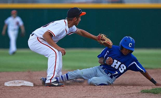 Josiah Pongassi slides under the tag of Douglas shortstop Zac Davies in a win over the Tigers Thursday afternoon at Tiger Field.