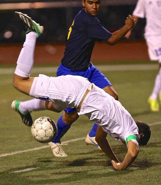 Senator Oscar Ventura is upended by a Reed player Wednesday night at Carson High.