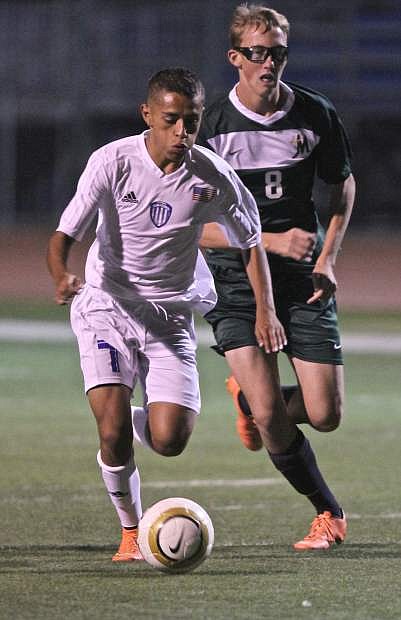 Senior forward Octavio Virrueta drives towards the goal in a game against the Bishop Manogue Miners at Carson High Wednesday night.