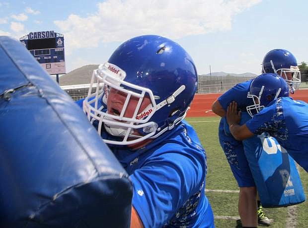 Lineman Logan Menzel works on a blocking drill during practice on Tuesday.