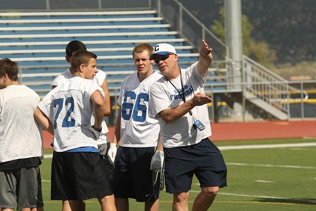 Head coach Blair Roman gives instruction to players on the first day of spring practice on Monday.