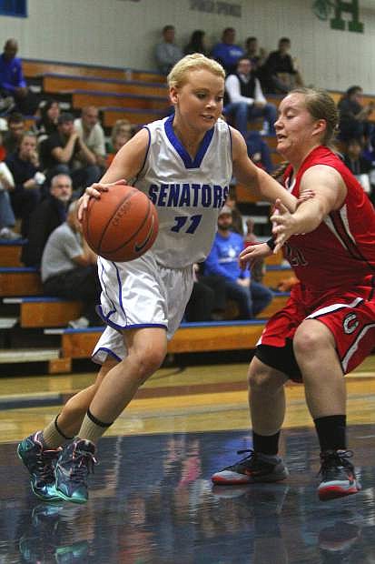 Senior power forward Kayla Aikins (11) moves past a Wooster player Friday night in a win against the Colts at home.