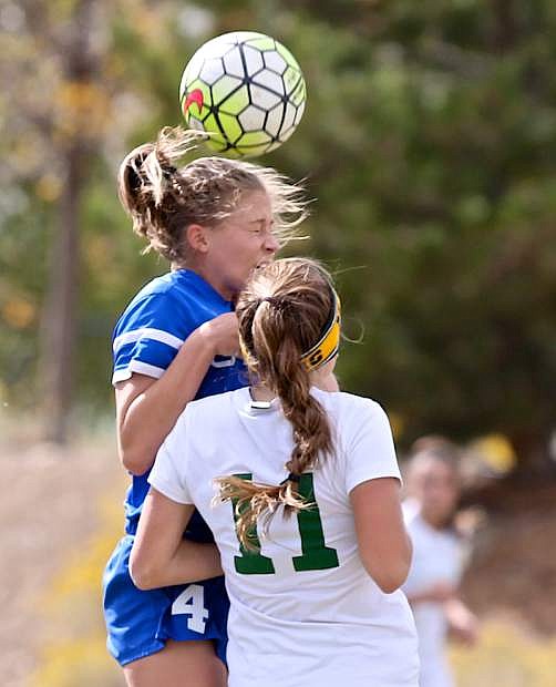 Senior Lauren Hudak heads the ball in a game against the Manogue Miners Saturday in Reno.