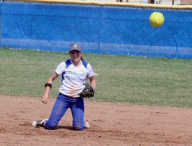 Carson High shortstop Bailey Allen watches her throw to first after making a diving stop last season.