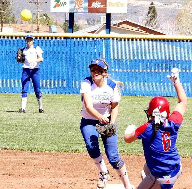 Carson shortstop Bailey Allen completes a double play with a throw to first during Saturday&#039;s game against Reno.