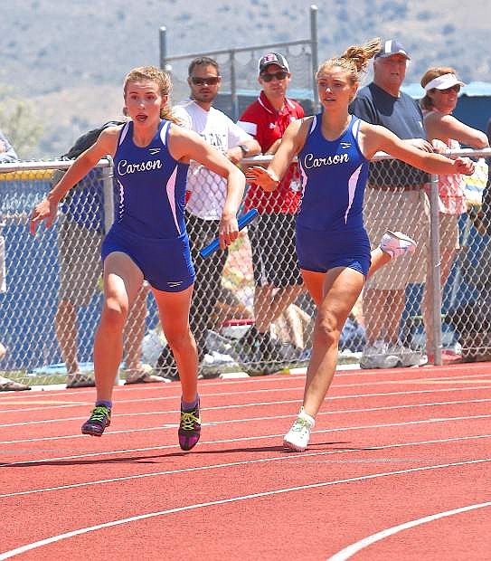 Carson&#039;s Athena Favero exchanges the baton to ValerieSue Meyer during the girl&#039;s 4x200-meter relay Saturday at the Jim Frank Track and Field Complex. The Carson team won the event.
