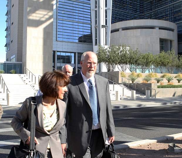 CORRECTS DATE TAKEN - One-time political powerbroker Harvey Whittemore leaves the Lloyd George Federal Courthouse in Las Vegas, Wednesday, April 3, 2013. Whittemore was attending a hearing on whether to toss out the evidence in the campaign contribution case against him. The woman next to him is unidentified. (AP Photo//Las Vegas Review-Journal, Jerry Henkel)