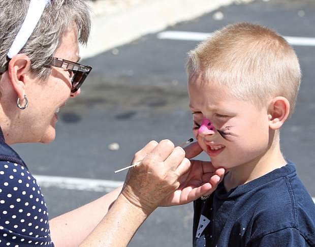 6-year-old Silas Lokey has his face painted by Carson-Tahoe&#039;s Laurie Burt Saturday.