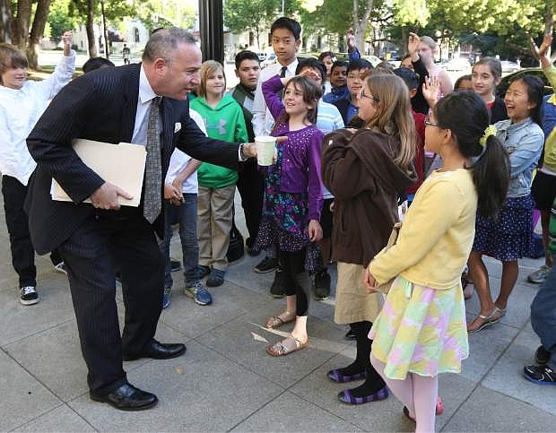 Senate President Pro Tem Darrell Steinberg, D-Sacramento, pauses to talk with fifth grade students from Deterding Elementary School, before he attended an ethics training session in Sacramento, Calif., Wednesday, April 23, 2014.  Steinberg ordered all state senators and top aids to a day of ethics training in the wake of criminal charges against three Democratic senators.(AP Photo/Rich Pedroncelli)