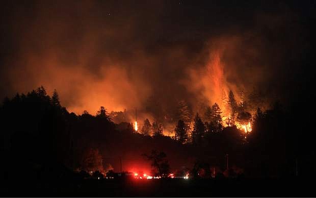 A wind driven vegetation fire eats up timber  at the Yellow Jacket Ranch east of Highway 128, early Wednesday May 1, 2013 in Knights Valley, Calif., on the Napa and Sonoma County line. Crews battled two small wildfires on Wednesday in California wine country that were pushed by gusty winds. (AP Photo/The Press Democrat, Kent Porter)