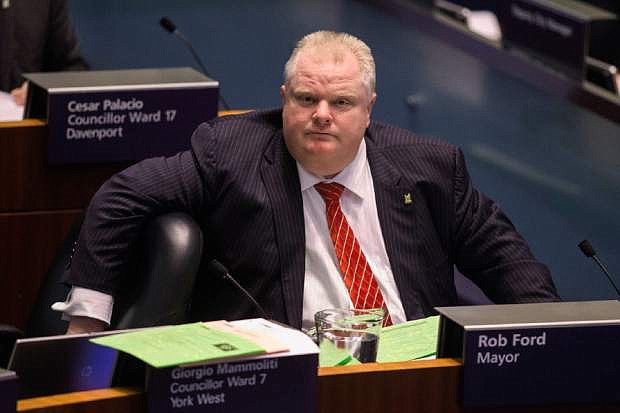Toronto Mayor Rob Ford attends a council meeting as councillors look to pass motions to limit his powers in Toronto on Monday Nov. 18, 2013.   Under the motion, already endorsed by a majority of council members, Ford would in effect become mayor of Canada&#039;s largest city in name only. The council does not have the power to remove Ford from office, barring a criminal conviction. It is pursuing the strongest recourse available after recent revelations that Ford smoked crack cocaine and his repeated outbursts of erratic behavior. Ford has vowed to take the council to court and insists he will seek re-election next year. (AP Photo/The Canadian Press, Chris Young)