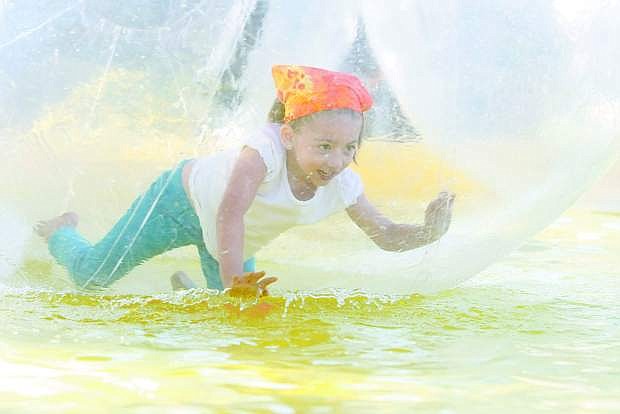Five-year-old Mia Beck crawls around in a water ball at a previous Candy Danc.e