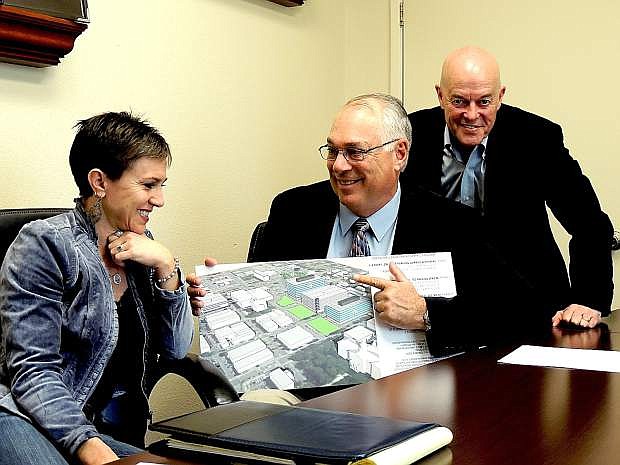 Andie Wilson, of NAI Alliance, Rob Hooper, director of Northern Nevada Development Authority, and Bruce Robertson of NAI, discuss the Capitol Mall project last week.