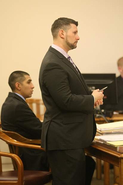 Jesse Kalter asks a question during testimony in district court on Friday while Leonardo Cardoza looks on.