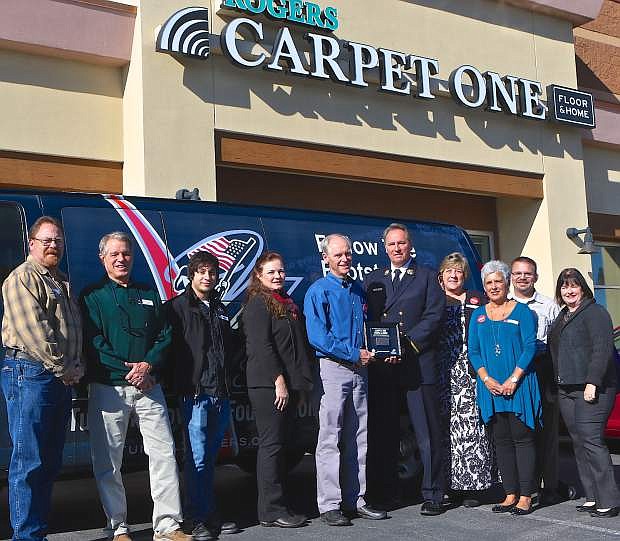 Employees of Roger&#039;s Carpet One on Topsy Lane, along with Carson City Supervisor Lori Bagwell (far right) pose for a picture with FDNY Battalion Commander John Martorana (5th from right) Thursday.