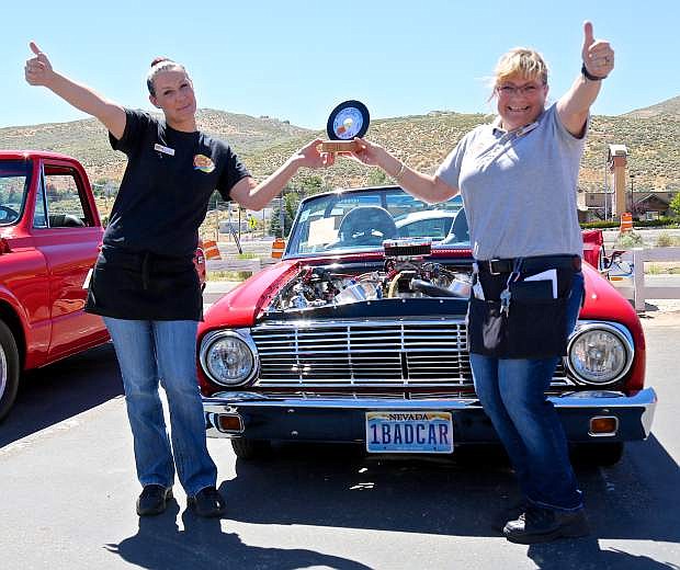 Johnny Rockets Supervisor Lisa Sassenerg and General Manager Tamara Chavez hold up a trophy for Ken Martinez&#039; 63 Ford Falcon which was their pick for the best in show at the Karson Kruzers Show-n-Shine Saturday.