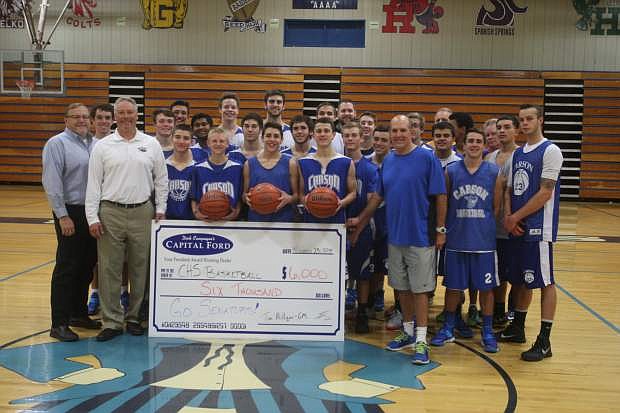 Tim Miiigan, general manager of Capital Ford and Cliff Sorensen director of Carson Auto Group present a $6,000 check to Coach Mendeguia and the Carson High School boys basketball team. The money will be used for travel and equipment,