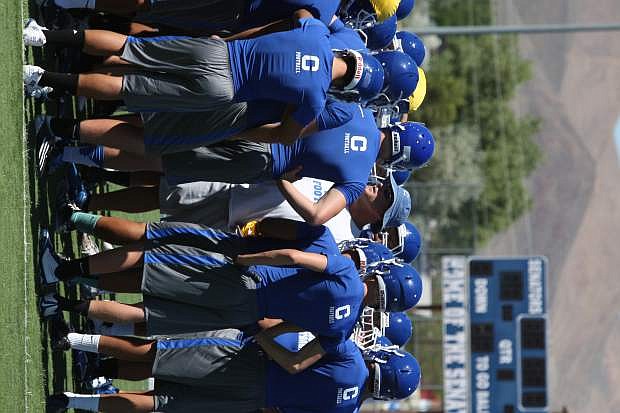 Carson&#039;s head football coach Blair Roman runs huddles with his team Friday afternoon at Carson High.