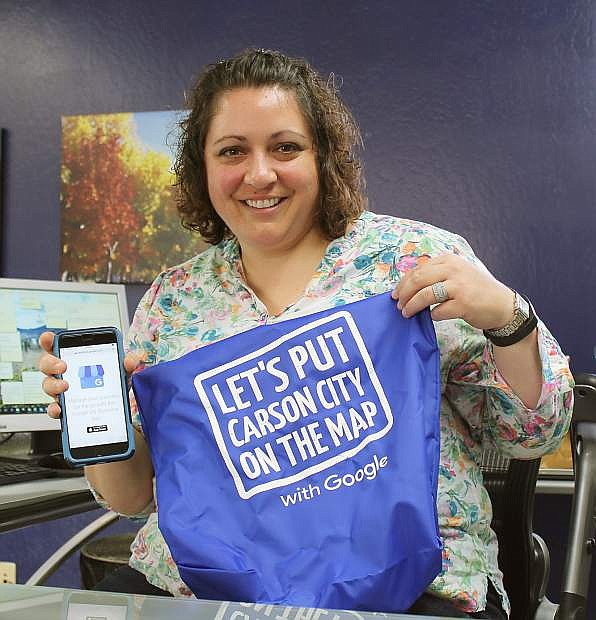 Carson City/Storey County Educator Lindsay Chichester proudly shows the Google SWAG bag she received after being the first Chamber client to put the Carson City extension office on Google.