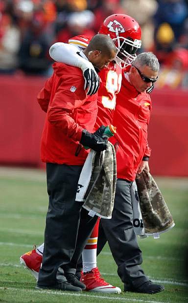 Kansas City Chiefs outside linebacker Tamba Hali (91) is helped from the field during the first half of an NFL football game against the San Diego Chargers in Kansas City, Mo., Sunday, Nov. 24, 2013. (AP Photo/Ed Zurga)