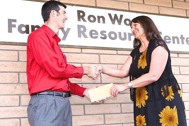 Save Mart Store Manager Chris Benson presents Joyce Buckingham, Exec. Director of the Ron Wood Family Resource Center, a $2031 check on Thursday.