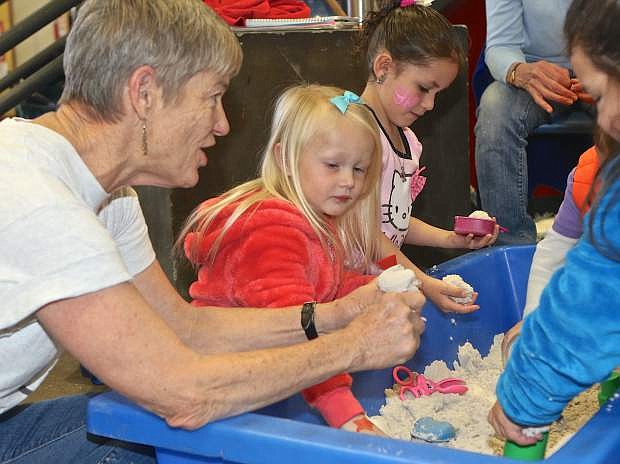 Mark Twain Elementary&#039;s Paula Baum helps some children&#039; at the Boys and Girls Clubs Saturday.
