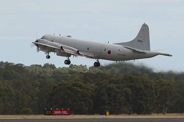 A Japan Maritime Self-Defense Force P-3C Orion takes off from the Royal Australian Air Force Pearce Base to commence a search for possible debris from the missing Malaysia Airlines flight MH370, in Perth, Australia, Monday, March 24, 2014. Satellite images released by Australia and China had earlier identified possible debris in an area that may be linked to the disappearance of the flight on March 8 with 239 people aboard. (AP Photo/Paul Kane, Pool)