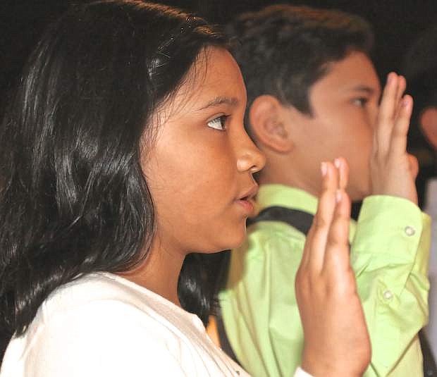 10-year-old Dana Fernandez states her Oath of Allegiance during the U.S. citizenship ceremony held at the Nevada State Museum Wednesday.