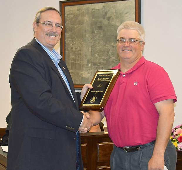 Mayor Ken Tedford Jr., left, presents Randy Beeghly with a plaque for being employee of the quarter.