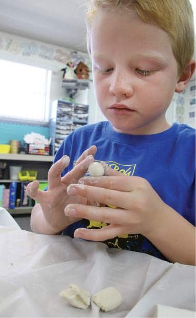 Fritsch Elementary School second-grader Eric Billings works on a clay art project.