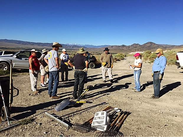 Cleanup starts on a BLM Adopt-A-Site near Basalite Quarry east of Dayton with BLM Program Coordinator Corey Gardner, in the pink hat, who holds a safety meeting with residents of Copper Canyon Estates.